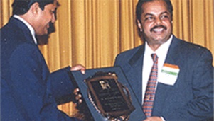 Dr. Majeed receiving the award for Entrepreneurial Excellence by Asian American Heritage Group in 1997